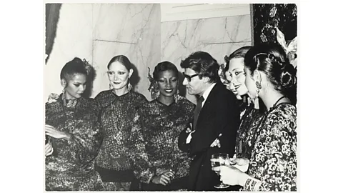 Musée Yves Saint Laurent Paris “Fashion is like a party,” said the designer, pictured here with models at the Paris launch of Opium (Credit: Musée Yves Saint Laurent Paris)