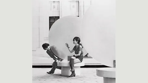 Photo by Iain MacMillan/Copyright Yoko Ono Lennon John and Yoko sitting next to George Adamy’s artwork Month of June, 1970, in New York, 4 September 1971 (Credit: Photo by Iain MacMillan/Copyright Yoko Ono Lennon)