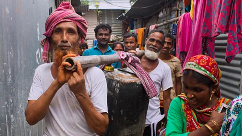 Lou Del Bello Carrying water through the camps after collecting it is a laborious task (Credit: Lou Del Bello)