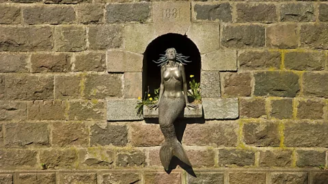 mauritius images GmbH/Alamy Residents say that if you stare into the eyes of the Užupis Mermaid as you enter the republic, you’ll never want to leave (Credit: mauritius images GmbH/Alamy)