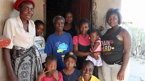 Rachel Nuwer Grandmother Rudo Chinhoyi, in the blue t-shirt, surrounded by a few of her three children, nine grandchildren and eight great-grandchildren (Credit: Rachel Nuwer)