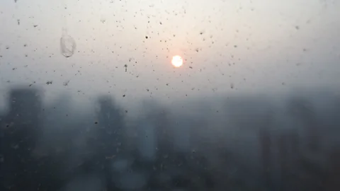 Getty Images Pollution and smog make the sun hazy behind a dirty window in Beijing, China (Credit: Getty Images)