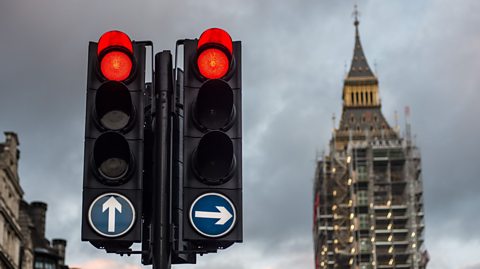 Red traffic lights near the houses of parliament