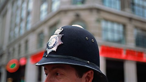 the top of a policeman's head, wearing a hat