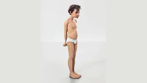 Ron Mueck, courtesy the artist/collection of Amy & John Phelan/Anthony d’Offay Mueck posed as Geppetto for Rego, holding his 1996 sculpture, Pinocchio, shown here (Credit: Ron Mueck, courtesy the artist/collection of Amy and John Phelan and Anthony d’Offay)