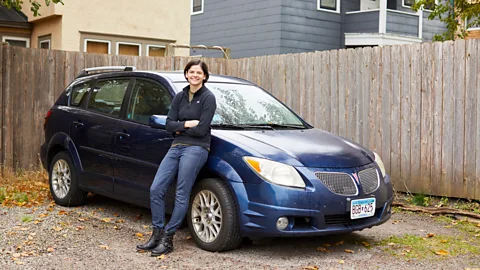 Anna Rajdl Minneapolis resident Gwen Merz, 28, drives a 13-year-old car to help her stash away money for early retirement (Credit: Anna Radjl)