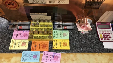 The Chin Men's tellers still stamp each entry by hand