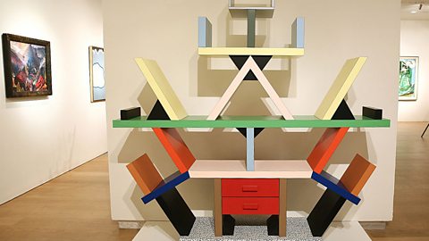 A colourful abstract bookcase displayed in an art gallery.