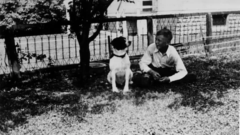 Schulz Family Intellectual Property Trust Charles Schulz and his dog Spike in 1935, when Schulz was 13 years old (Credit: Schulz Family Intellectual Property Trust/Courtesy the Charles M Schulz Museum and Research Center)