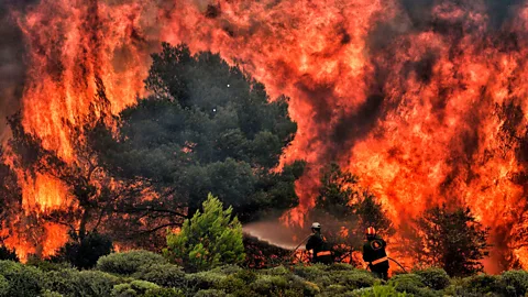 Getty Firefighters battle flames near Athens in July 2018, where at least 74 people were killed (Credit: Getty)