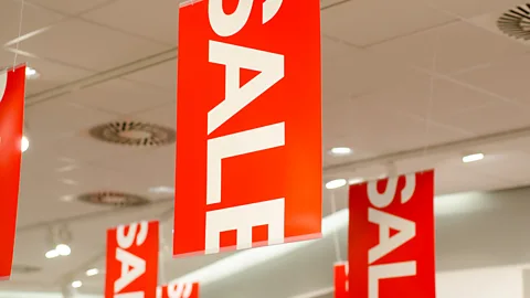 Getty Sale signs hanging in a store (Credit: Getty)