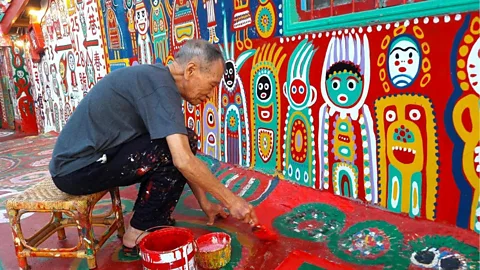 Rainbow Village Huang Yung-fu's paintings spill outside and onto the village’s abandoned buildings (Credit: Rainbow Village)