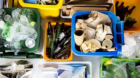 Boxes of organised glass, plastic and glass recycling.