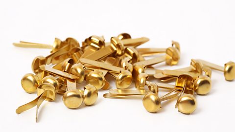 A pile of split pins are shown against a white background.