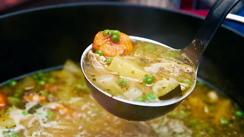 Getty Images A ladle lifting chicken soup (Credit: Getty Images)