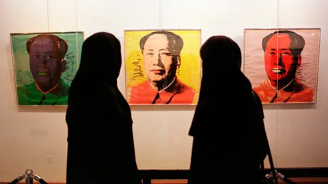 Getty Images Visitors view Andy Warhol’s portrait of Mao Tse-tung at TMoCA (Credit: Getty Images)