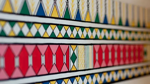 ERIC LAFFORGUE/Alamy Many Qahtani customs have survived with the outside world, including the colourful murals painted by women on the walls of their homes (Credit: ERIC LAFFORGUE/Alamy)