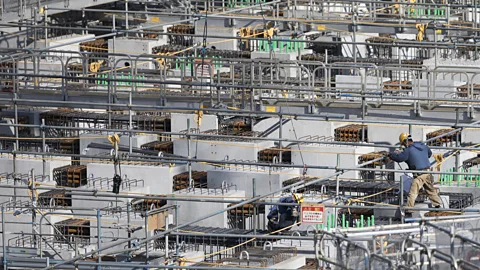 Getty Images As Tokyo barrels toward the 2020 Summer Olympics, labour shortages in venue construction have demanded help from workers abroad (Credit: Getty Images)