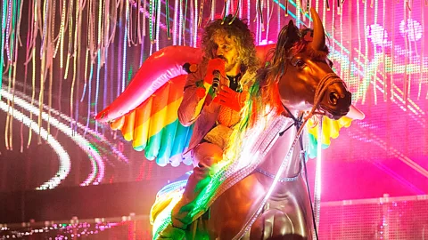 Getty Wayne Coyne of The Flaming Lips riding a fake unicorn on stage is just one example of the recent resurgence of unicorns in popular culture (Credit: Getty)