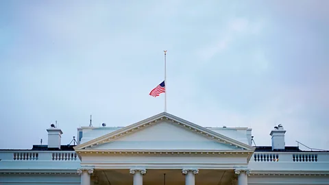 Getty Images The US flag above the White House flies at half-mast (Credit: Getty Images)