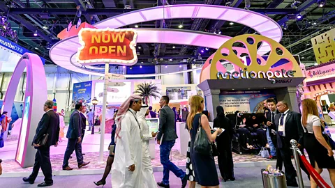 Getty Images Visitors pass the Dubai Parks and Resorts stand during the Arabian Travel Market 2017 (Credit: Getty Images)