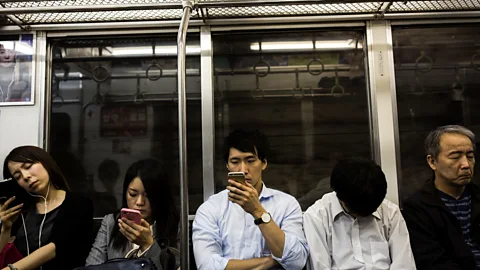 Getty Images Subway commuters in Tokyo. Life in the 21st Century is defined by our constant exposure to and use of personal technologies (Credit: Getty Images)