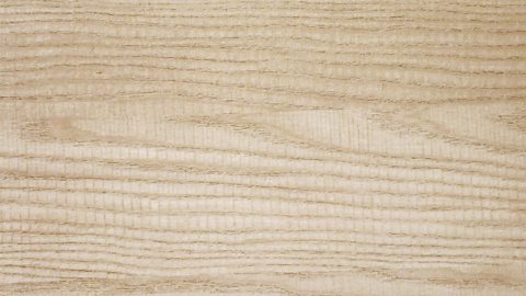 The texture of ash wood - pale with slightly darker lines running through.