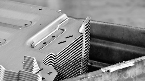 A stack of car parts produced by an accurate sheet metal stamping tool die.