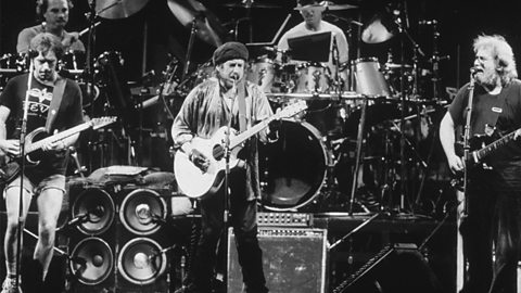 Bob Dylan performing on stage with the Grateful Dead.