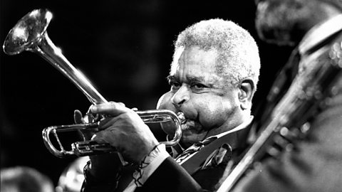 A photograph of an older Dizzy Gillespie performing in 1988.