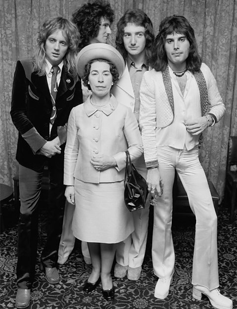 The band Queen with a Her Royal Highness Queen Elizabeth II look-a-like.