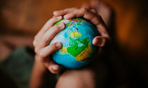 A globe being held by someone