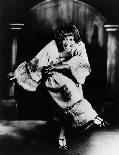 A photograph of Bessie Smith in action on stage.