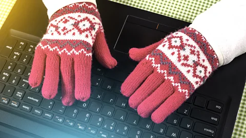 Getty Images Air conditioning in modern offices often leaves some people feeling so cold that they have to put on extra layers (Credit: Getty Images)