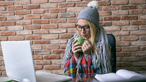 Getty Images Wearing a coat indoors can raise your average skin temperature, meaning that the temperature drop can feel more extreme when you do venture outside (Credit: Getty Images)