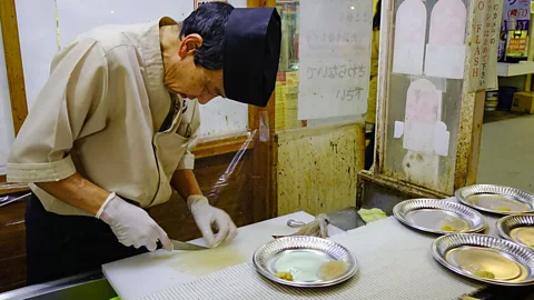 Duy Phuong Nguyen/Alamy Ikizukuri involves preparing and serving the squid while it’s still alive, while katsu ika odori don uses one cut to remove the head of the squid (Credit: Duy Phuong Nguyen/Alamy)