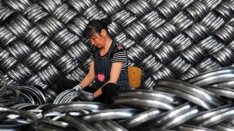 Getty Images A worker in China checks wheel hubs ready to be exported (Credit: Getty Images)