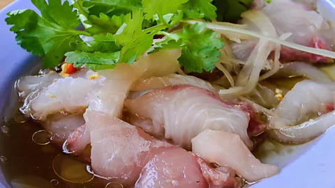 Kuchinta/Getty Images Yu sheng’s roots are in ancient China, where legend says it was invented by a couple who survived on fish and vinegar while trapped during a storm (Credit: Kuchinta/Getty Images)