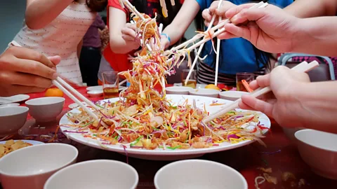 Alexlky/Getty Images Yu sheng, a raw-fish salad served during Chinese New Year, is said to guarantee prosperity when tossed (Credit: Alexlky/Getty Images)