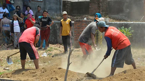 Mark Eveleigh Bengkala’s kolok community often find work as security guards and gravediggers because of their reputation for being brave (Credit: Mark Eveleigh)