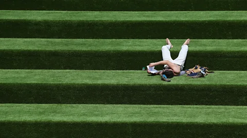 Getty Images Man reading on grass Getty Images 173221534