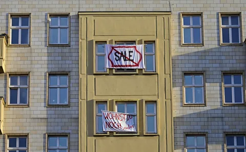 Getty Images Tenants protest the sale of apartments on the most prominent boulevard in old Communist East Germany to Berlin's largest property company (Credit: Getty Images)