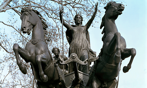 Statue of Boudicca in London. She is riding a chariot pulled by two horses.