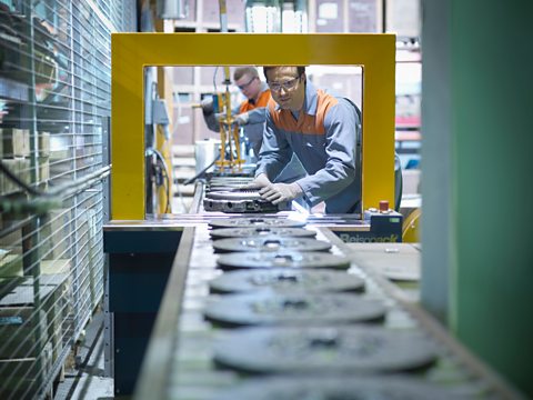 Workers on production line in industrial clutch factory