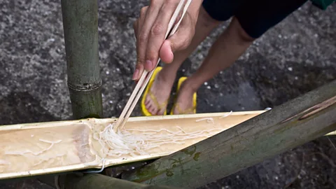 acritely_photo/Alamy Nagashi somen, which involves catching ice-cold somen noodles as they float down a chute, is a popular Japanese summer pastime (Credit: acritely_photo/Alamy)