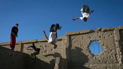 Tanya Habjouqa/NOOR Gaza, June 2013: The Gaza Parkour and Free Running team practice in a cemetery on the outskirts of their refugee camp (Credit: Tanya Habjouqa/NOOR)