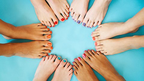 6 pairs of feet each with painted toenails form a circle