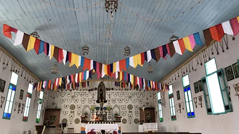 Andrew Evans Tepoto's residents are predominantly Catholic and often attend mass in the island's one church every day. (Credit: Andrew Evans)