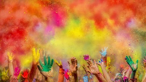 Coloured gulal powder being thrown at Holi festival