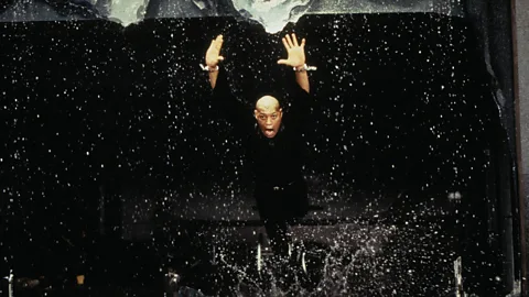 Alamy Neo’s mentor Morpheus (Laurence Fishburne) is interrogated by the evil Agent Smith (Hugo Weaving) in a corporate skyscraper (Credit: Alamy)